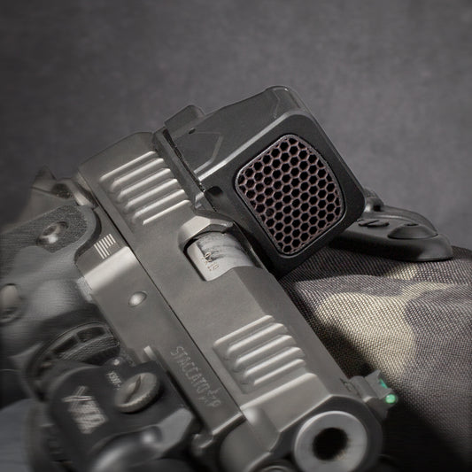 Black Optic Scope Cover with GlareGard Killflash Lens Installed for Holosun® 507 Comp - Laying on holster