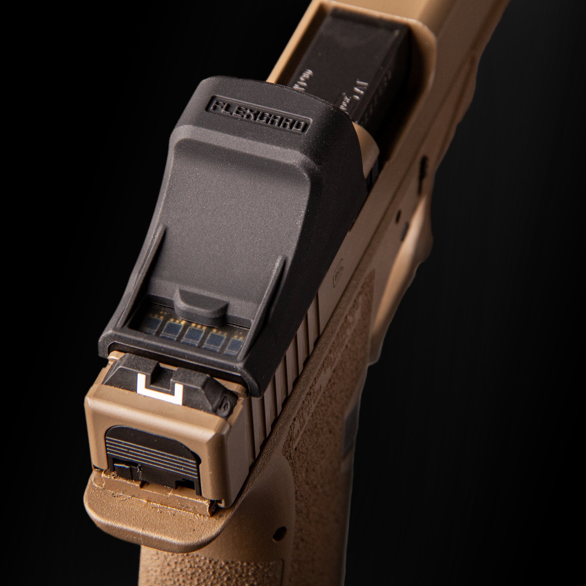 Close-up of a FlexGard Rubber Dust Cover for Holosun SCS MOS mounted on a FDE handgun [ads-hide]