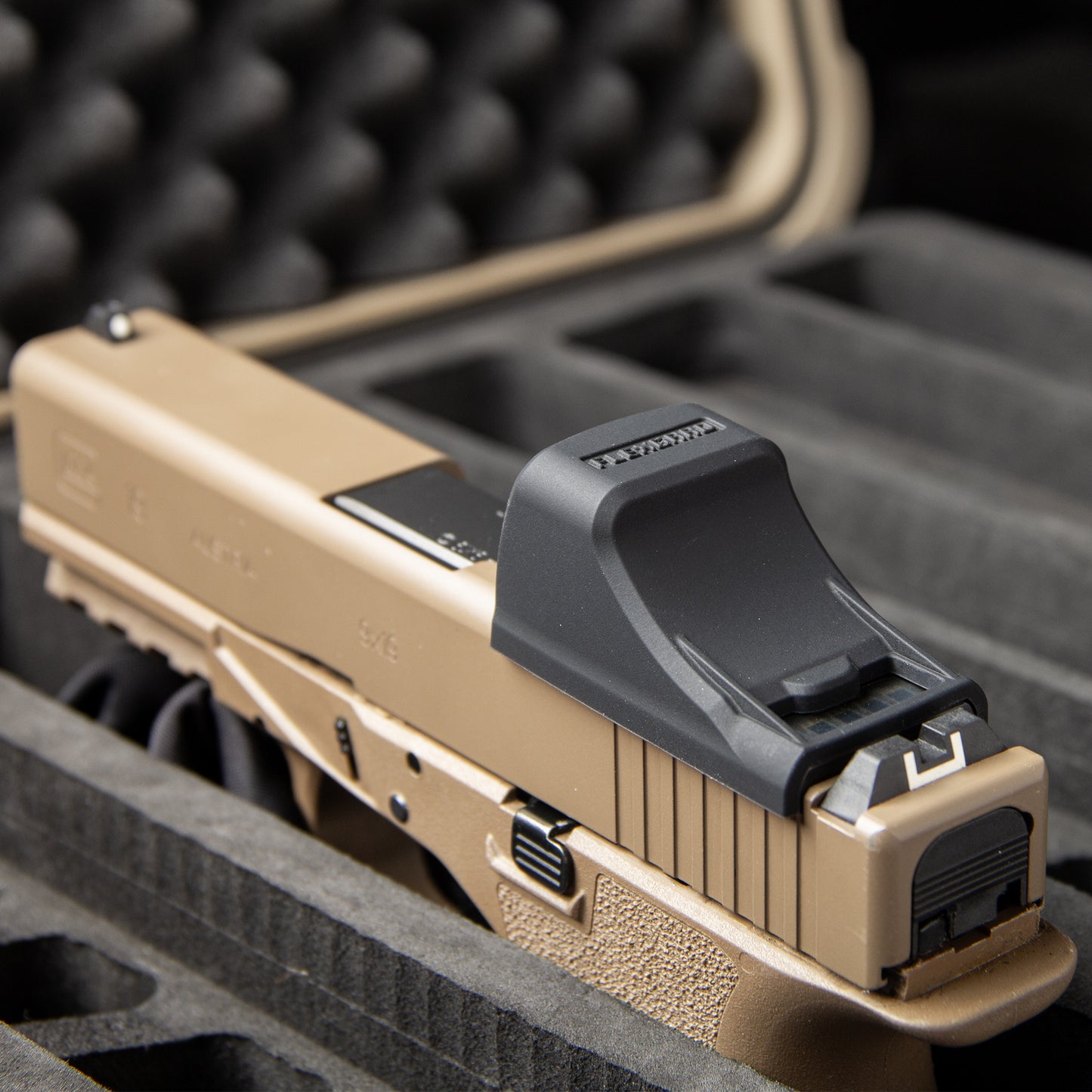 Close-up of a FlexGard Rubber Dust Cover for Holosun SCS MOS mounted on a FDE handgun [ads-hide]