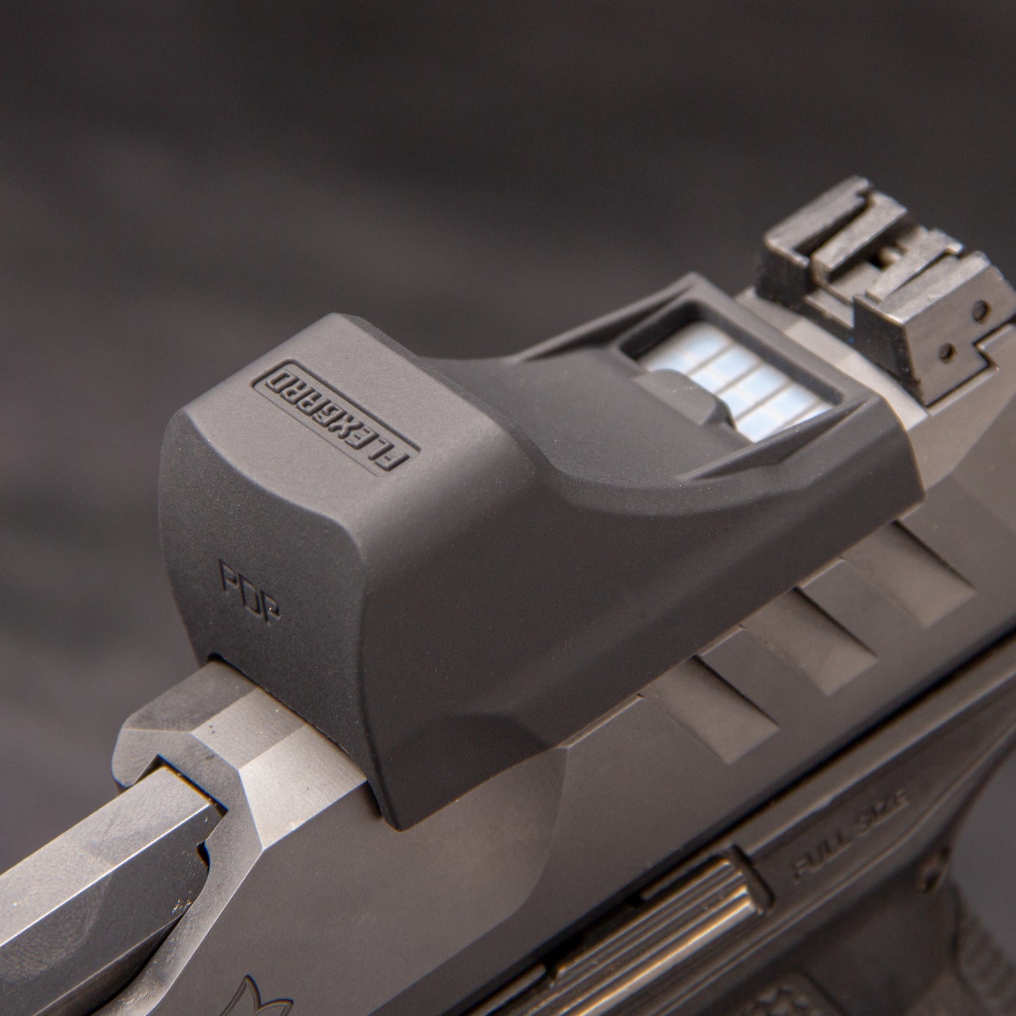 Close-up of a FlexGard Rubber Dust Cover for Holosun SCS PDP mounted on a handgun [ads-hide]