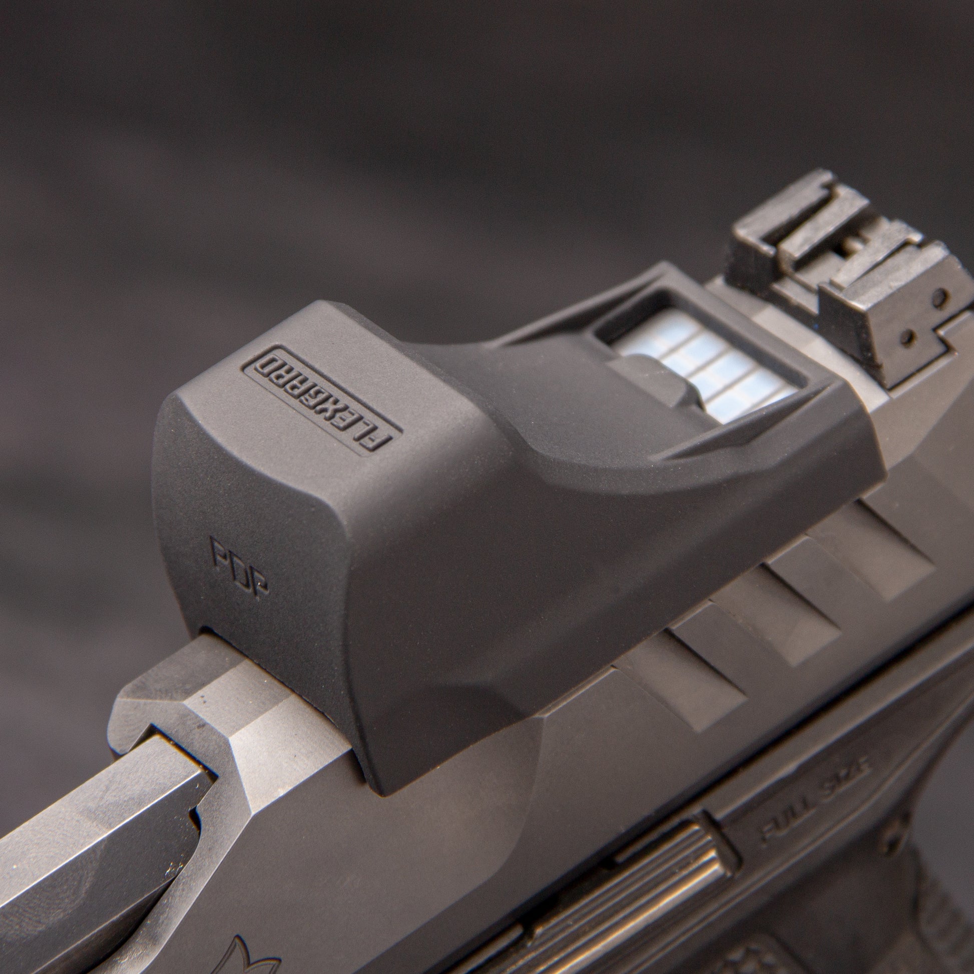 Close-up of a FlexGard Rubber Dust Cover for Holosun SCS PDP mounted on a handgun [ads-hide]