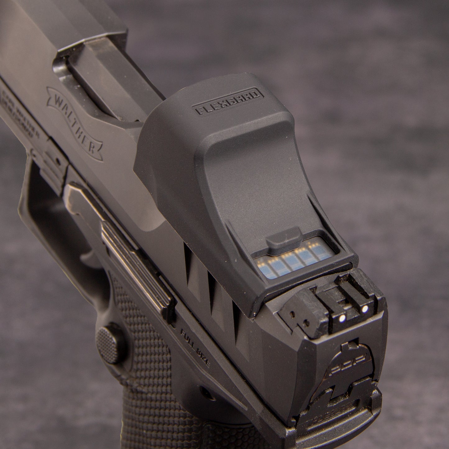 Close-up of a FlexGard Rubber Dust Cover for Holosun SCS PDP mounted on a handgun [ads-hide]