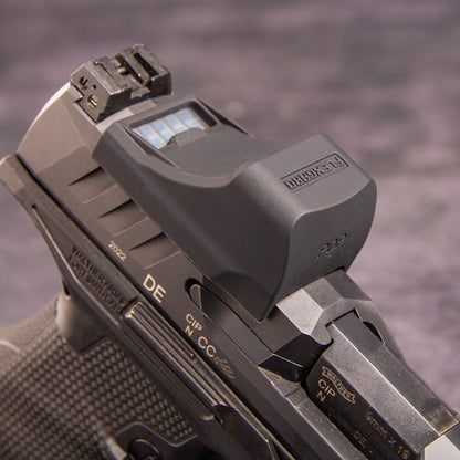 Close-up of a FlexGard Rubber Dust Cover for Holosun SCS PDP mounted on a dark metallic handgun, showing the sight's textured cover and the slide markings. [ads-hide]
