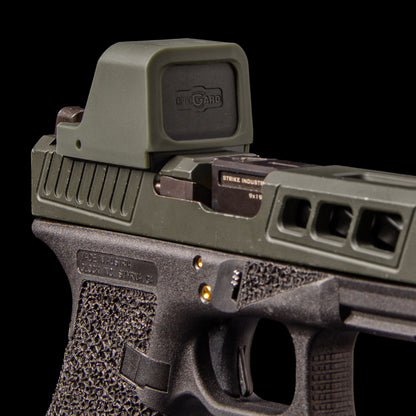 Close-up of a semi-automatic handgun with an OpticGard Cover , a black foregrip, and a visible Strike Industries logo on the slide, set against a solid black background
[ads-hide]